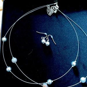 Silver wire necklace with shiny and pave type balls.